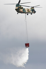 JASDF CH-47 Large transport helicopter discharging water from a basket