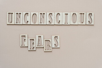 unconscious fears - sign with wood type