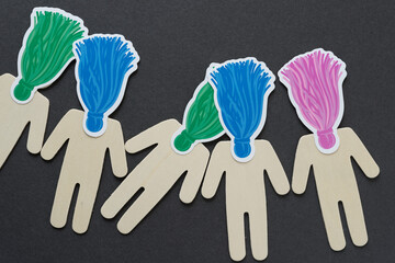 Naklejka premium wooden figure silhouettes with ornamental halftone tassels arranged on their heads