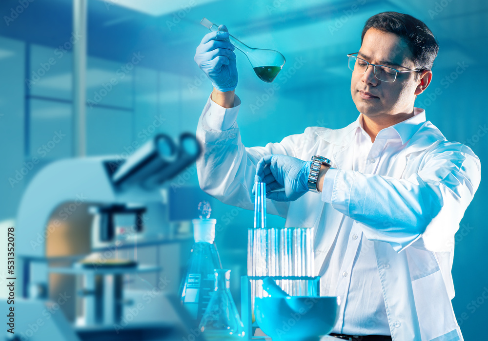 Poster student in laboratory. young man with test tube. student laboratory assistant notes time. microscope