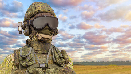 Infantry soldier. Soldier in modern military uniform. Army clothes. Military uniform for infantry. Infantryman in protective helmet and goggles. Military uniform mannequin on blurred nature background