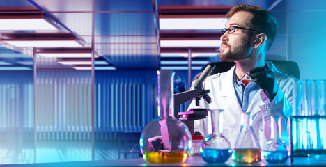 Scientist biologist. Young man laboratory assistant. Biological research concept. Microscope on...