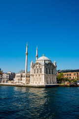 Fototapeta na wymiar Ortakoy Camii (mosque) under clear blue skies in Kadikoy, Turkiye.