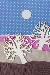 two ornate wooden tree silhouettes on fancy scrapbook paper and paper circle