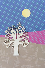 isolated ornate wooden tree silhouette on scrapbook paper with paper circle