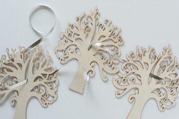 ornate wooden tree silhouettes with metallic curling ribbon on paper
