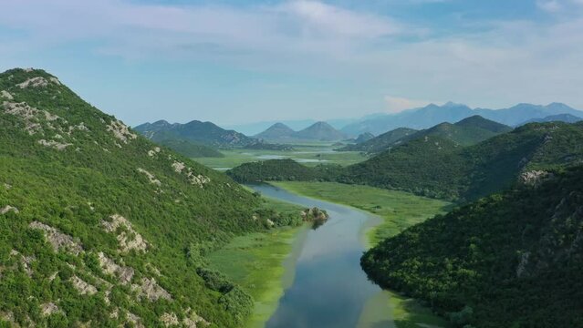 Aerial view of Rijeka Crnojevica - beautiful river between mountains flowing into Skadar Lake, Montenegro, 4k