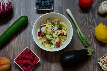 Flat lay of various fruits and vegetables on wooden table