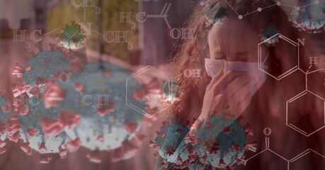 Covid-19 cells and chemical structures against woman wearing face mask sneezing 