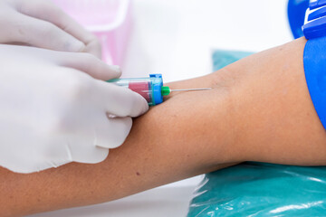 Nurse collecting a blood from patient in hospital