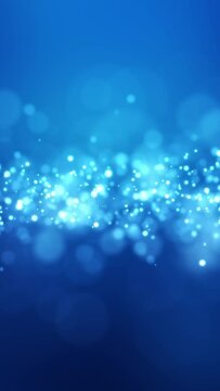 Video animation of blue light shine particles bokeh over blue background - abstract particles background - vertical video