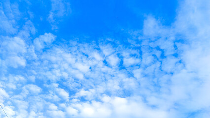 Bright clear blue sky. Various kind of clouds. Cirrocumulus clouds.