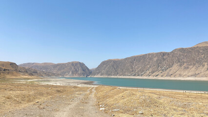 Panorama of the rocky mountains and hills of Kyrgyzstan. Beautiful mountain lake.