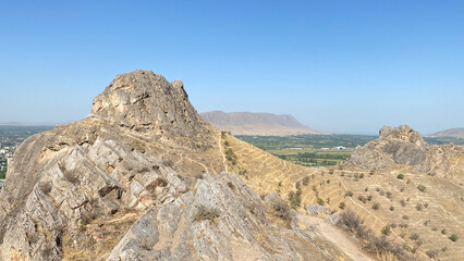 Rocky sacred mountain and symbol of the city of Osh - Sulaiman-Too. View of the city from a bird's eye view.