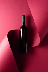 Keuken foto achterwand Bottle of red wine on a red background. © Igor Normann