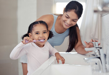 Brushing teeth, girl or mother teaching learning child personal hygiene, dental care or healthcare in house or family home bathroom. Happy smile woman, parent and kid in wellness with sink toothbrush - Powered by Adobe