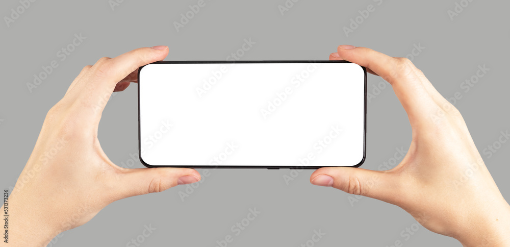 Poster hands holding phone mockup in horizontal position on grey background. female watching video. using d