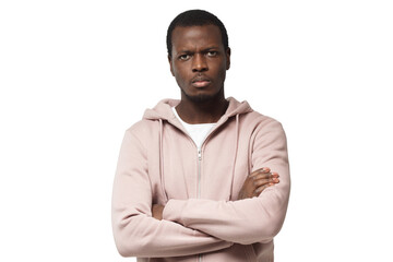 Horizontal shot of young good-looking black male looking with anger, with arms crossed, feeling of pressure and tension