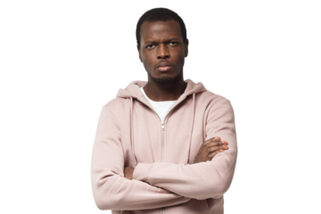 Horizontal shot of young good-looking black male looking with anger, with arms crossed, feeling of pressure and tension