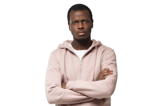 Horizontal shot of young good-looking black male looking with anger, with arms crossed, feeling of pressure and tension