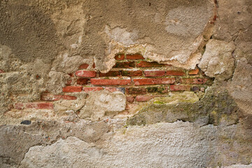 cracked wall with brick structure seeing through