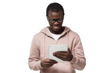 Closeup portrait of young handsome African guy in hipster clothes looking attentively at screen of white tablet computer