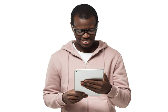 Closeup Portrait Of Young Handsome African Guy In Hipster Clothes Looking Attentively At Screen Of White Tablet Computer