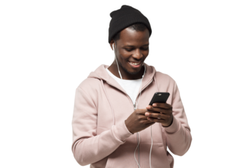 Young handsome black guy in pink hoodie and black hat, listening music with headphones and looking at screen of his smartphone