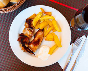Delicious fried pork slices with appetizing French fries and sauce