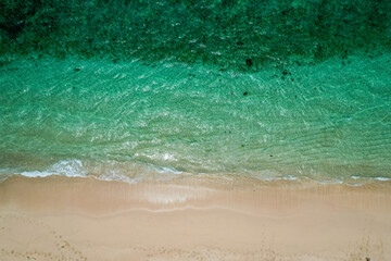 Big waves breaking on the beach - clear beautiful turquoise blue ocean sea and clouds in the sky - Bali