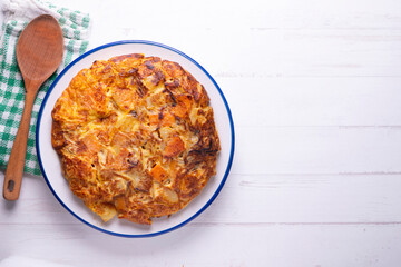 Potato and sweet potato omelette. Modern Spanish recipe of the traditional tortilla tapa.
