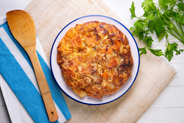 Potato and sweet potato omelette. Modern Spanish recipe of the traditional tortilla tapa.