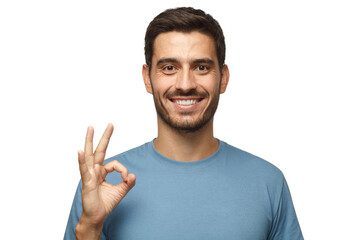 Young smiling man having happy look, gesturing, showing OK sign or showing okay gesture with his...