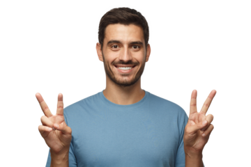 Indoor portrait of young male with optimistic smile, showing victory gesture with both hands