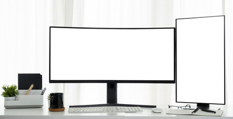 Front view of large curved and vertical computer monitor with blank display on a white table.