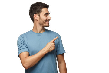 Casual dressed young man in blue t-shirt looking right, pointing with his finger - 531379650
