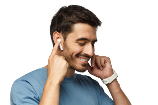 Young man wearing wireless earbuds and blue t shirt, listening to his favorite musical album online, touching one earphone to control application