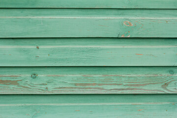 Fototapeta premium An old wooden wall painted turquoise, weathered wooden background.