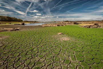 Fotobehang Land cracked by drought in the Molano reservoir. © Eduardo Estellez/Wirestock Creators