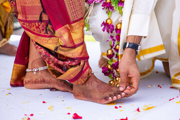 South Indian Tamil bride's feet ring exchange wedding ceremony close up