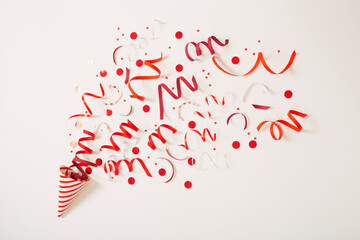 striped birthday hat with confetti on white background