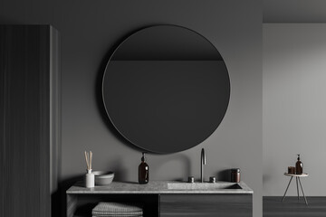 Grey bathroom interior with sink and mirror, accessories on deck