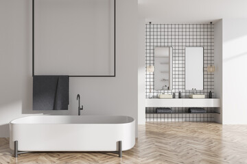 Light bathroom interior with bathtub and washbasin, accessories