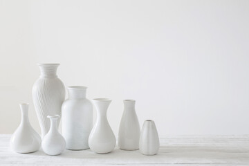 ceramic white vases on white background - obrazy, fototapety, plakaty