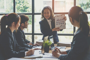 Business meeting concept brainstorming financial analyst financial report on graph document during corporate meeting discussion Demonstrates successful teamwork.