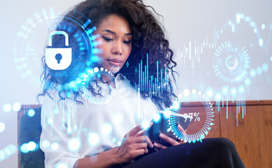 African businesswoman using tablet, forex diagrams with candlesticks, padlock