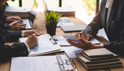 Business meeting concept brainstorming financial analyst financial report on graph document during corporate meeting discussion Demonstrates successful teamwork.