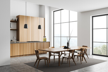 Light kitchen interior with table and chairs, cooking and eating area, window