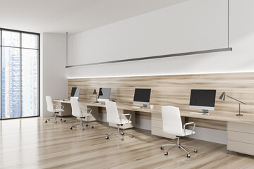 Light business interior with pc computer, desk and panoramic window on city view