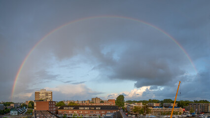 full rainbow over city